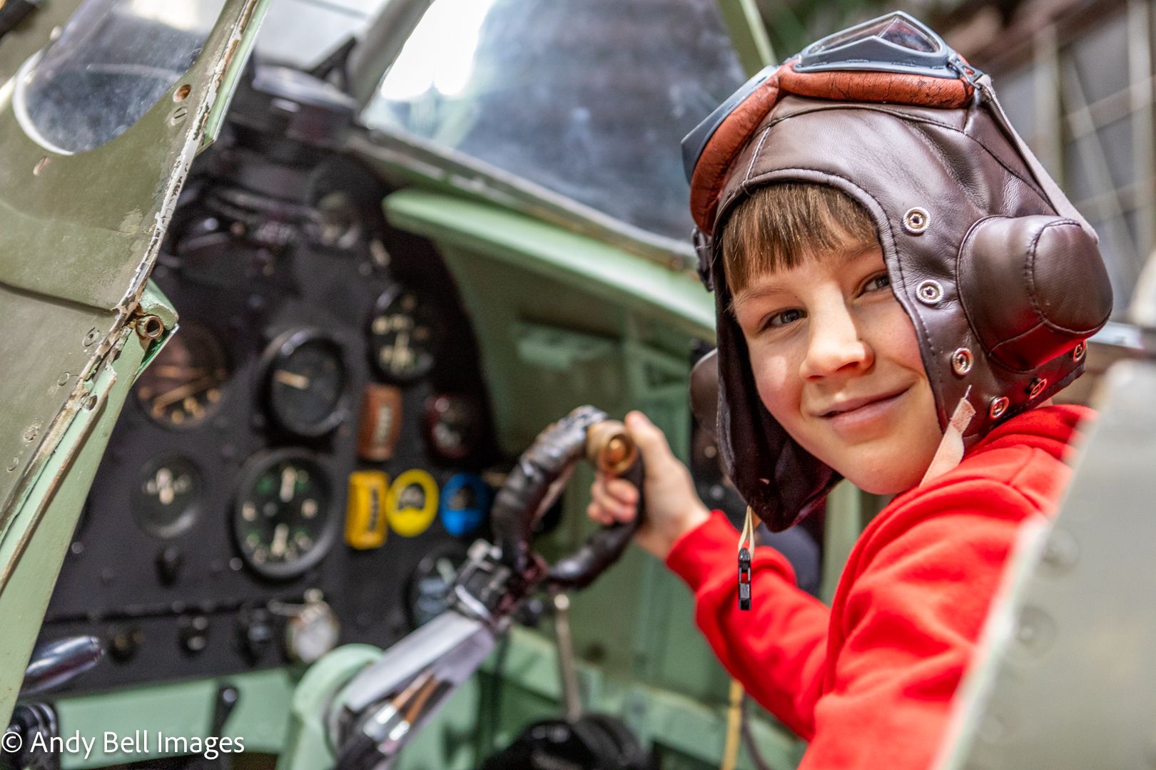 A child at the controls of an iconic aircraft at the Spitfire Visitor Centre: Hangar 42, Blackpool