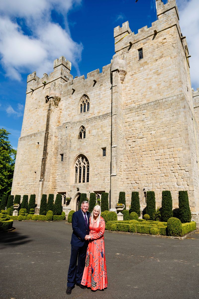 Baron and Baroness of Langley, Dr Stuart and Dr Mariann Madnick, outside the medieval castle that Dr Stuart turned into a hotel and restaurant in 1986.