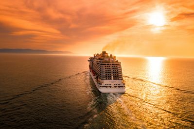 A cruise ship sailing into the sunset