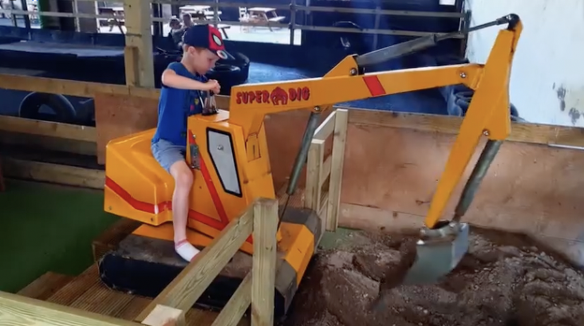 Child on digger at the Lakeland Maze Farm Park in Sedgwick near Kendal