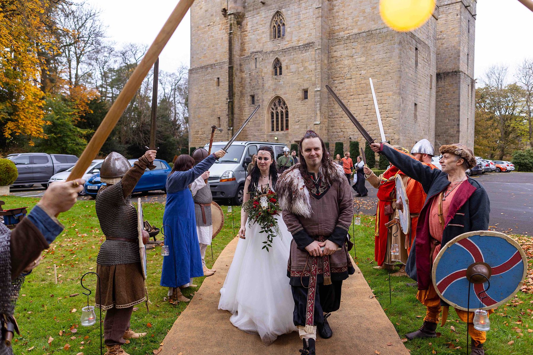 Benjamin and Annmarie Coomber, heading to  the tipi at medieval Langley Castle, Northumberland, on the day of their Viking wedding