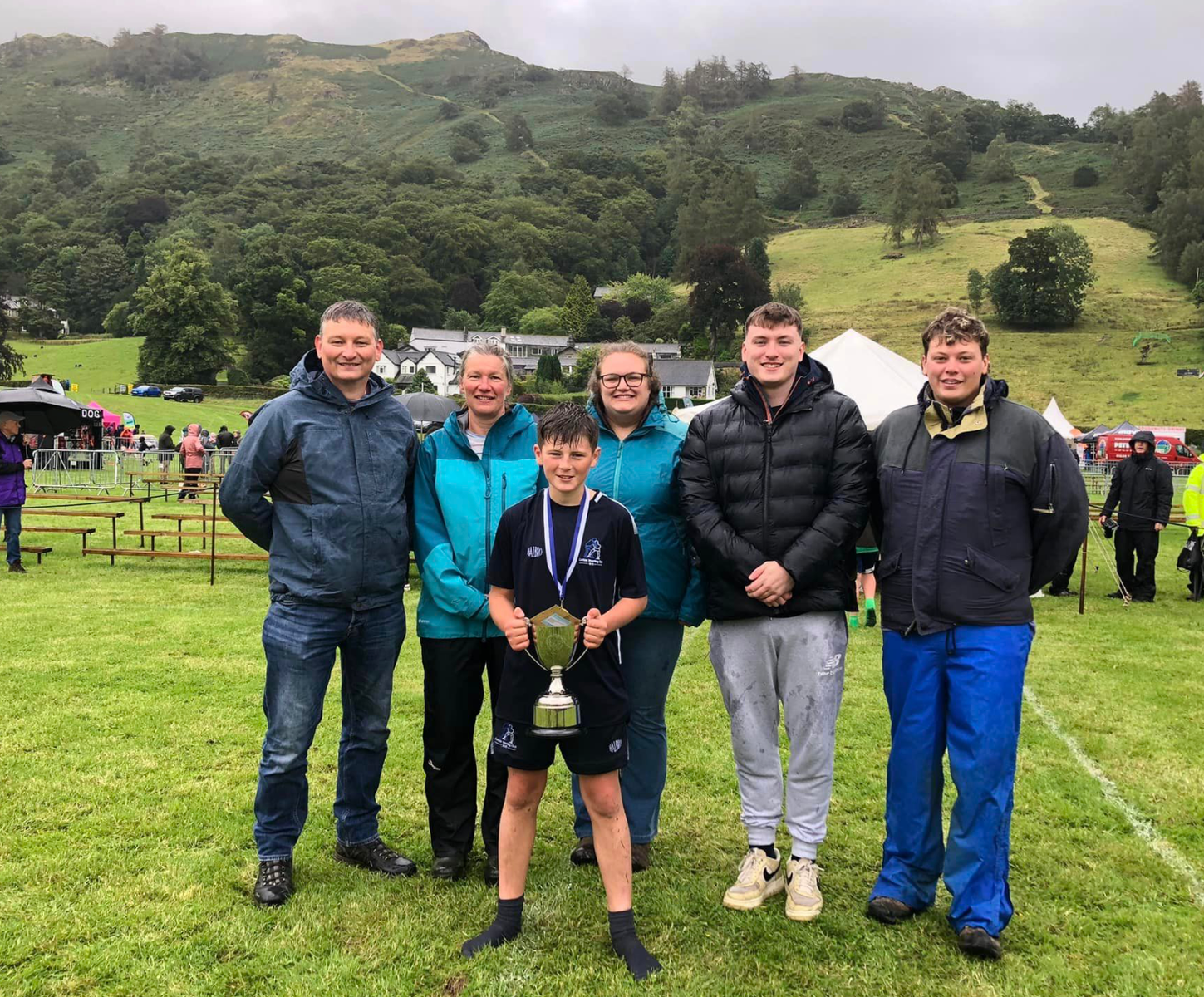 Winner of the Roger Robson Memorial Trophy in the Under 12s Mixed wrestling event, Ollie Stainton of Gilsland, with member of the Robson family, Simon, Catherine, Anna, Edward and George.