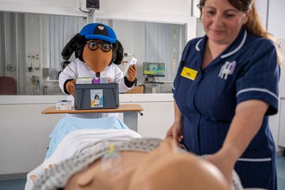 PA images - Palliative specialist care nurse Ellie Gibson with Wellington Womble.JPG