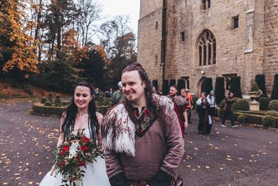 Benjamin and Annmarie Coomber, in front of medieval Langley Castle, Northumberland, on the day of their Viking wedding