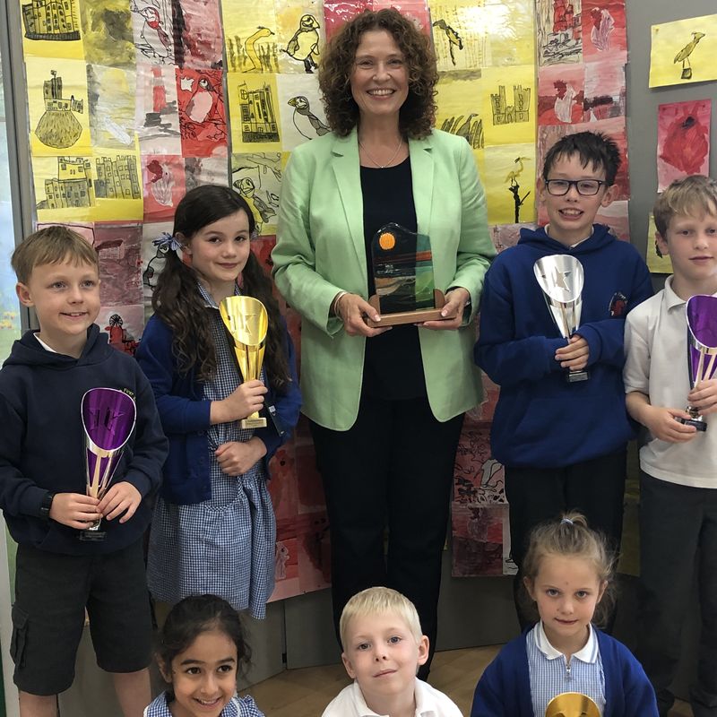 Stannington First School headteacher, Alex Palmer, proudly holding the Most Passionate School 'Northumbie' Award, presented by Northumberland Day, along with pupils