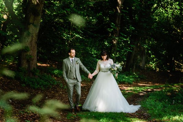 Bride and groom in the Woodland Wedding area at Langley Castle Hotel, Northumberland during a July 2021 castle wedding 