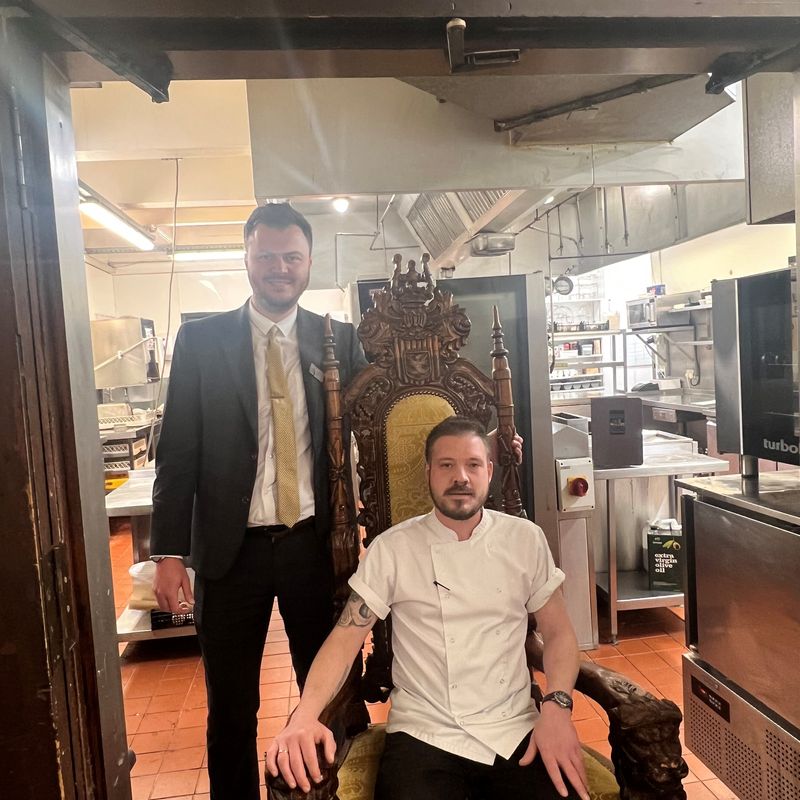 Langley Castle sous chef, Adam Phillips, in the Langley Castle kitchen (seated), with Food and Beverage Manager, Aiden McGuinness