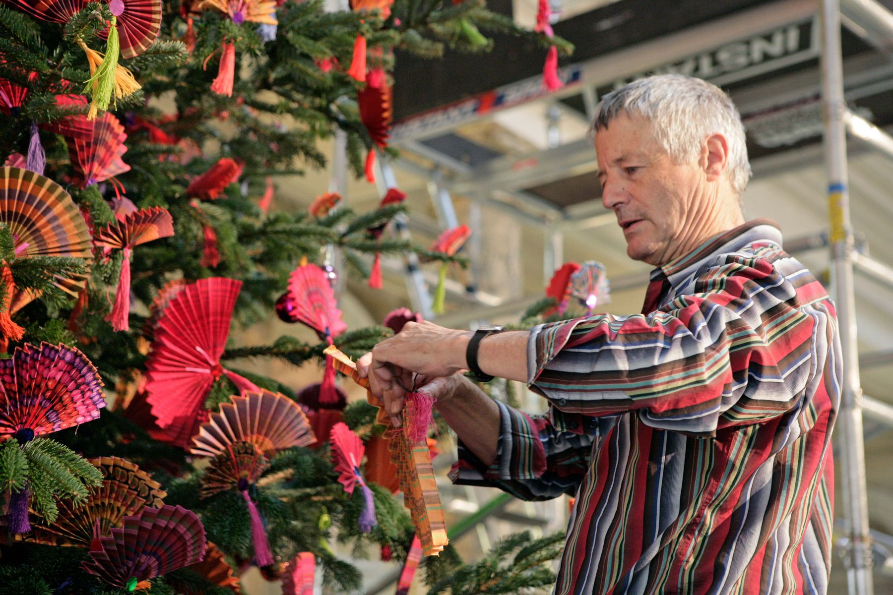 Kaffe Fassett, decorating a Christmas tree with his famous fans, 