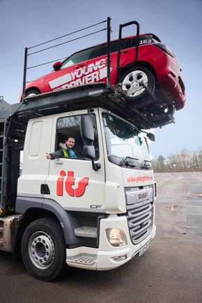 Bonnie (10) in the driver's seat of the delivery truck, bringing the new fleet of Suzuki Swifts to Young Driver