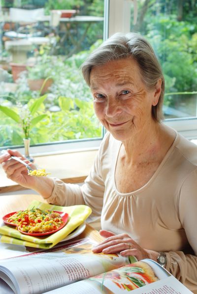 Lady eating vegetarian meal from a heart-shaped plate