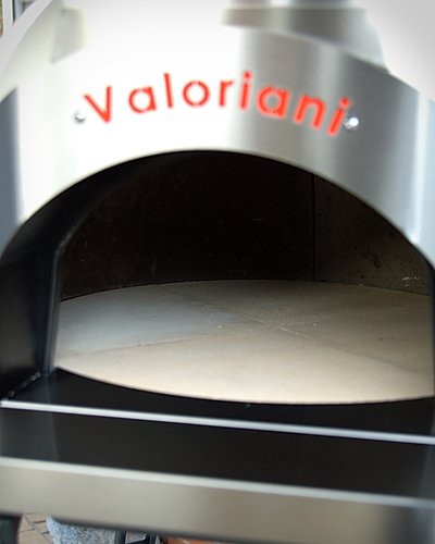 Close-up of the stainless steel front of a Valoriani Fornino 60 baby pizza oven