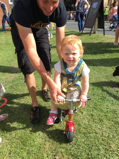 Toddler getting in on the Wonder Wheelers bicycle fun