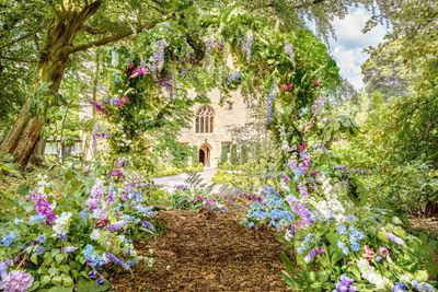 Floral arch feature in the new woodland wedding area at Langley Castle Hotel, Northumberland