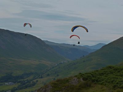 Paragliders flying over the fells close to the Grasmere Lakeland Sports and Show showfield.