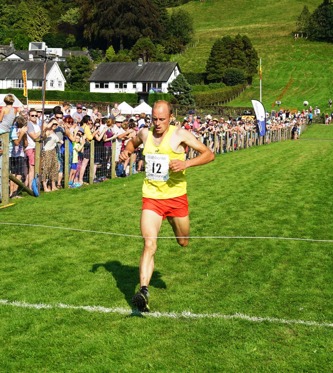 A fell runner crosses the finishing line at Grasmere Sports and Lakeland Show