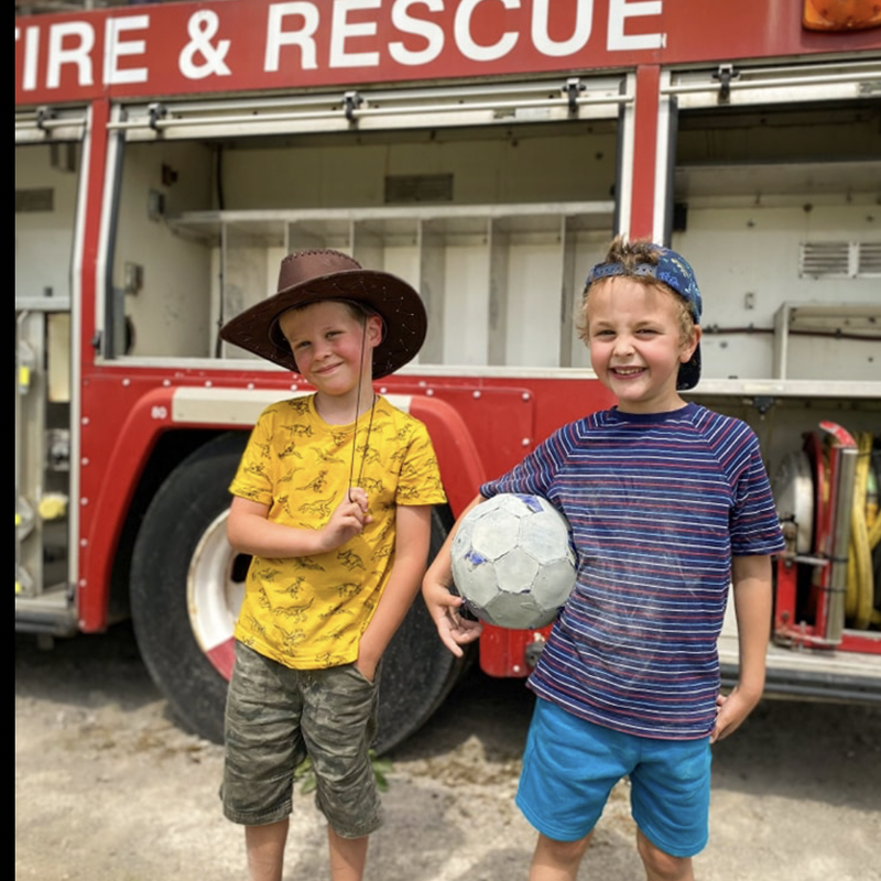 Two children play firefighter at the Lakeland Maze Farm Park