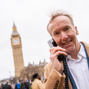 Michael Harrison, speaking on the Vodafone VT1 handset, recreating his iconic first UK mobile phone call 40 years on.jpg