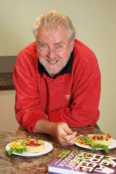 Man with two plates of vegetarian quiche