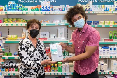 Kathryn Evans, 70, Bedworth, Nuneaton, receiving the 1 millionth message of Hope from former Blue Peter Presenter Radzi Chinyanganya at Well Pharmacy Bedworth
