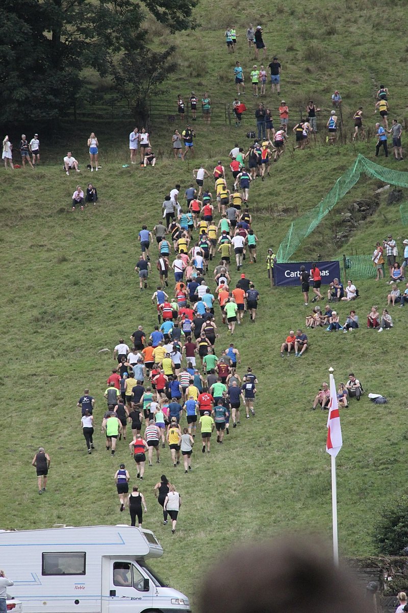 Runners heading up the fell at the start of a fell race at Grasmere Lakeland Sports and Show