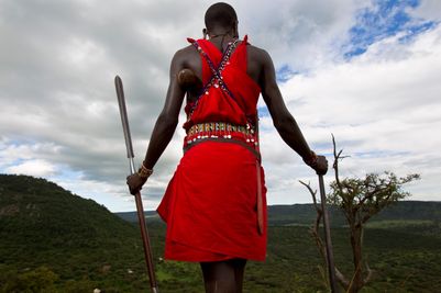 Masai and view of cottars camp.jpg