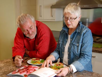 Couple looking at a vegetarian cook book