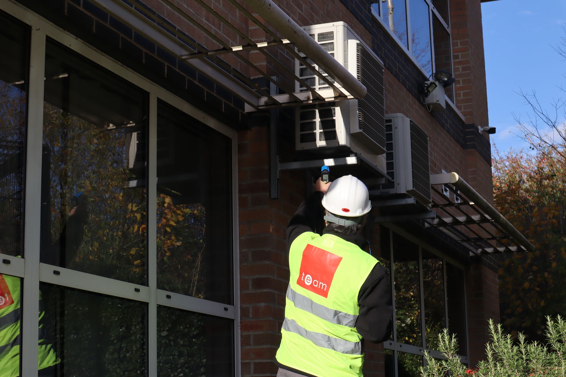 TEAM-Energy-consultant-Sam-Arje-checking-hvac-units.JPG