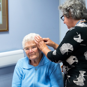 Volunteer Mary Anne Caruana with a visitor to the Bridgnorth Hearing Loss Hub.jpg