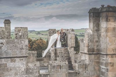Couple on the battlements of Langley Castle Hotel, Northumberland, UK.