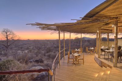 P_Asilia Lodges & Camps_Tanzania_Ruaha National Park 01_Jabali Ridge_Interiors_Exteriors_Dining room overlooking the baobab forest.jpg