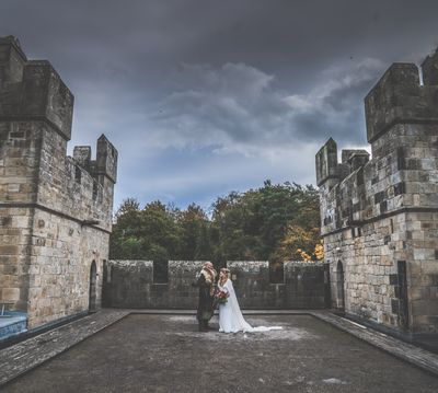 Bridal couple on the battlements at Langley Castle Hotel