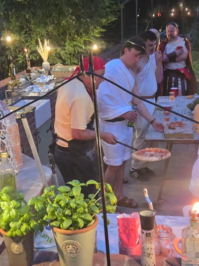 Andrew Manciocchi, owner of Orchard Ovens, cooking for guests at a customer's event, celebrating the 21st birthday of her son.