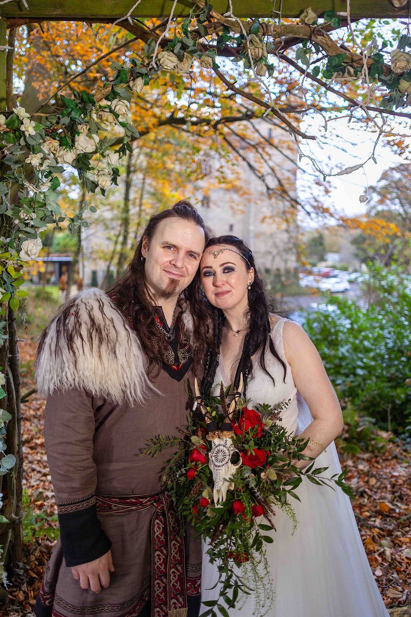 Benjamin and Annmarie Coomber, with a backdrop of Langley Castle, on the day of their Viking wedding.